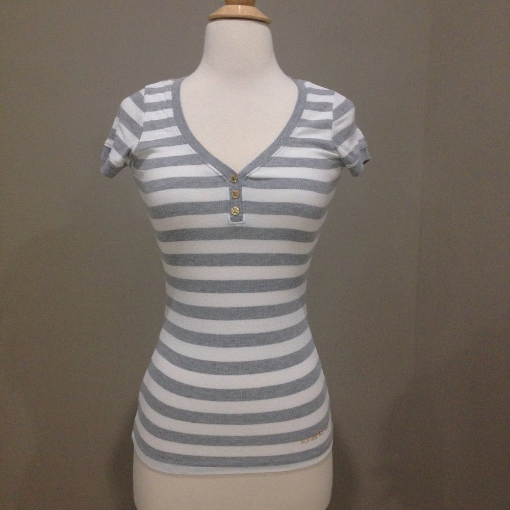 Bebe stretch fitted top with gold embellished logo.
